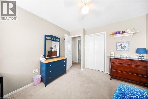 Bedroom with light colored carpet, a ceiling fan, and a closet - 132 Blackburn Drive, Brantford, ON - Indoor Photo Showing Bedroom