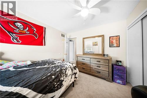 Bedroom with light colored carpet, a closet, and ceiling fan - 132 Blackburn Drive, Brantford, ON - Indoor Photo Showing Bedroom