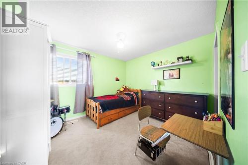 Carpeted bedroom featuring ceiling fan and a textured ceiling - 132 Blackburn Drive, Brantford, ON - Indoor Photo Showing Bedroom