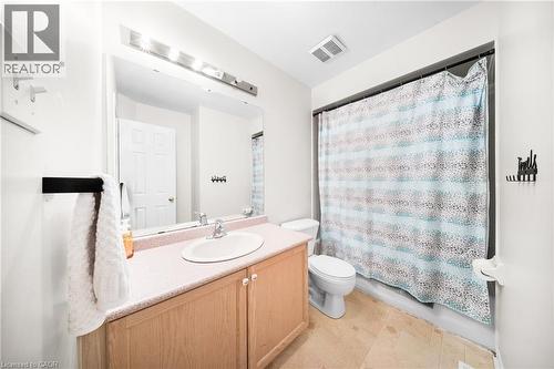 Full bathroom with vanity and shower / bath combo with shower curtain - 132 Blackburn Drive, Brantford, ON - Indoor Photo Showing Bathroom
