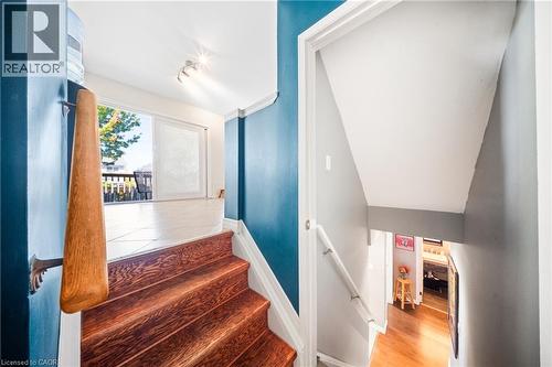 Staircase with wood finished floors - 132 Blackburn Drive, Brantford, ON - Indoor Photo Showing Other Room