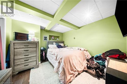 Bedroom with a paneled ceiling and wood finished floors - 132 Blackburn Drive, Brantford, ON - Indoor Photo Showing Bedroom