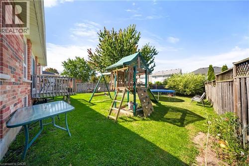 View of play area featuring a fenced backyard and a trampoline - 132 Blackburn Drive, Brantford, ON - Outdoor