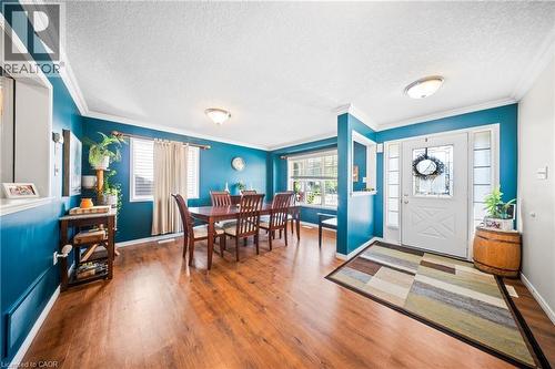 Entrance foyer with crown molding, a textured ceiling, and wood finished floors - 132 Blackburn Drive, Brantford, ON - Indoor