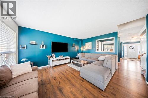 Living area featuring wood finished floors and baseboards - 132 Blackburn Drive, Brantford, ON - Indoor Photo Showing Living Room