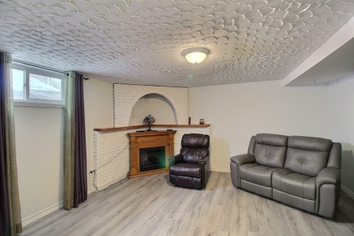 Salle familiale - 38 Av. Renaud, Rouyn-Noranda, QC - Indoor Photo Showing Living Room With Fireplace