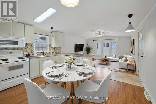 Eat-In Kitchen & Living Room - Virtual Staged - 4041 Ash Crescent, Severn, ON 