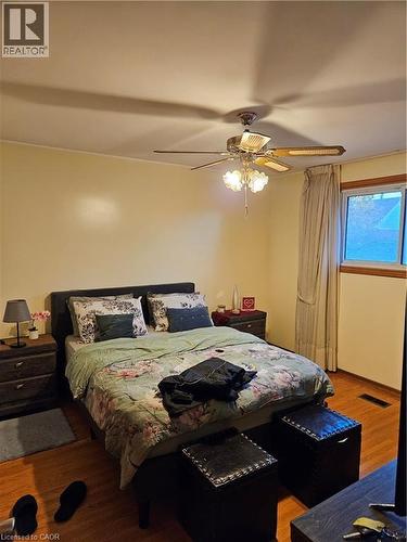 Bedroom featuring a ceiling fan and wood finished floors - 197 Craigroyston Road, Hamilton, ON - Indoor Photo Showing Bedroom
