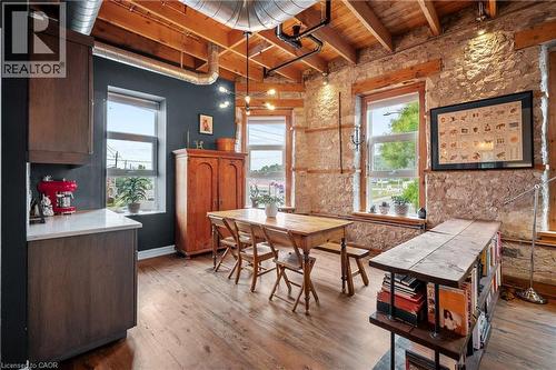 Dining room with wood-type flooring and a wooden ceiling with exposed beams - 25 Concession Street Unit# 201, Cambridge, ON - Indoor Photo Showing Other Room