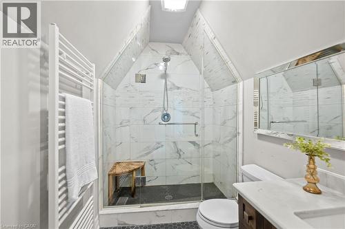 Full bathroom featuring vanity, radiator heating unit, a marble finish shower, and a towel warmer - 25 Concession Street Unit# 201, Cambridge, ON - Indoor Photo Showing Bathroom