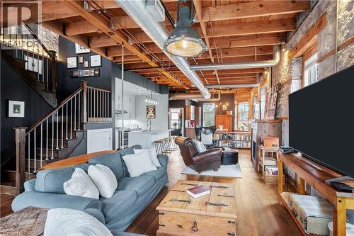 Living area featuring hardwood / wood-style floors and stairs - 25 Concession Street Unit# 201, Cambridge, ON - Indoor