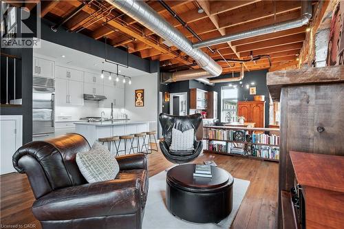 Living area with light wood-type flooring and a high ceiling - 25 Concession Street Unit# 201, Cambridge, ON - Indoor Photo Showing Basement