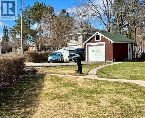 View of side yard with driveway, a garage, paver walkway and a large shed - 90 Osler Drive, Dundas, ON - Outdoor