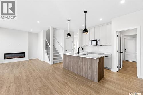 283 Nazarali Way, Saskatoon, SK - Indoor Photo Showing Kitchen With Fireplace