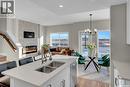 246 Kostiuk Crescent, Saskatoon, SK  - Indoor Photo Showing Kitchen With Fireplace With Double Sink 
