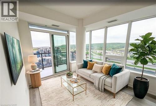 Sunroom / solarium featuring wood finished floors and baseboards - 385 Winston Road Unit# 1311, Grimsby, ON - Indoor Photo Showing Living Room