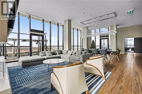 Living area with wood finished floors and a high ceiling - 385 Winston Road Unit# 1311, Grimsby, ON - Indoor