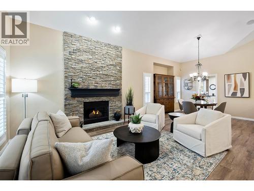 Living room / dining room - 3907 Gallaghers Circle, Kelowna, BC - Indoor Photo Showing Living Room With Fireplace
