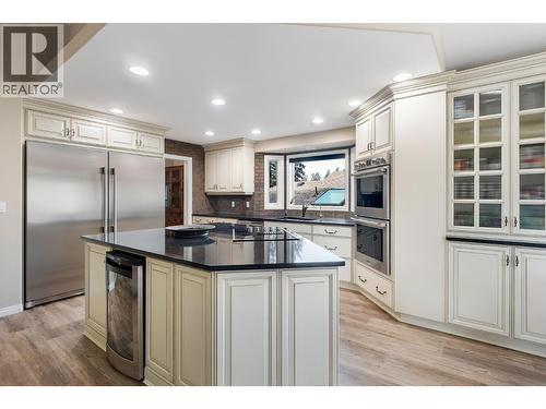 Side by side fridge & freezer, glass stove top & wine fridge - 3907 Gallaghers Circle, Kelowna, BC - Indoor Photo Showing Kitchen With Upgraded Kitchen
