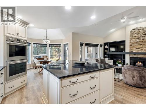 Double ovens - 3907 Gallaghers Circle, Kelowna, BC - Indoor Photo Showing Kitchen With Fireplace