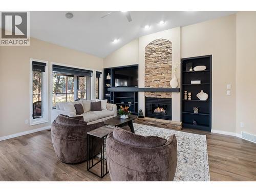 Fireplace in family room - 3907 Gallaghers Circle, Kelowna, BC - Indoor Photo Showing Living Room With Fireplace