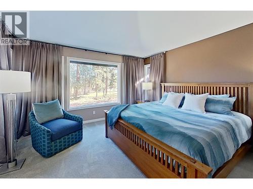 Primary bedroom with private view window - 3907 Gallaghers Circle, Kelowna, BC - Indoor Photo Showing Bedroom