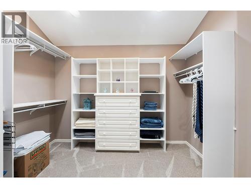 Primary bedroom walk in closet - 3907 Gallaghers Circle, Kelowna, BC - Indoor With Storage