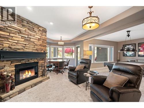 Recreation room with fireplace - 3907 Gallaghers Circle, Kelowna, BC - Indoor Photo Showing Living Room With Fireplace