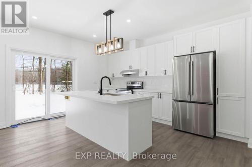 Kitchen, sliding doors to backyard - 49 Beaufort Crescent, Tiny, ON - Indoor Photo Showing Kitchen With Upgraded Kitchen