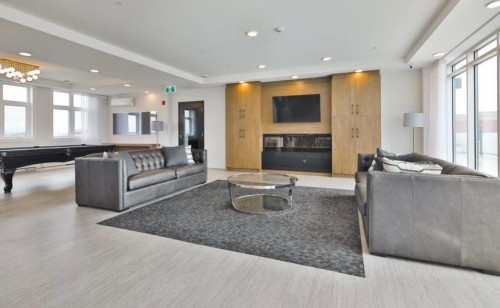 Salle communautaire - 109-8265 Rue De Londres, Brossard, QC - Indoor Photo Showing Living Room With Fireplace