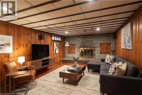 Virtually staged basement family room - 49 Dietz Avenue S, Waterloo, ON - Indoor Photo Showing Living Room With Fireplace
