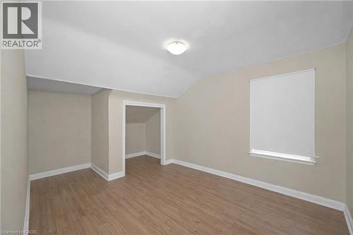 Additional living space featuring wood finished floors and vaulted ceiling - 43 Sterling Street, Hamilton, ON - Indoor Photo Showing Other Room