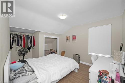 Bedroom featuring a closet, light wood-style flooring, and vaulted ceiling - 43 Sterling Street, Hamilton, ON - Indoor Photo Showing Bedroom