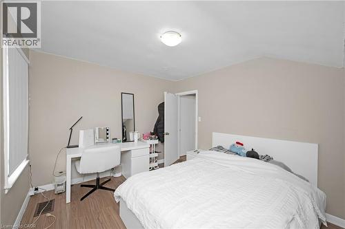 Bedroom featuring light wood-style flooring, a desk, and vaulted ceiling - 43 Sterling Street, Hamilton, ON - Indoor Photo Showing Bedroom