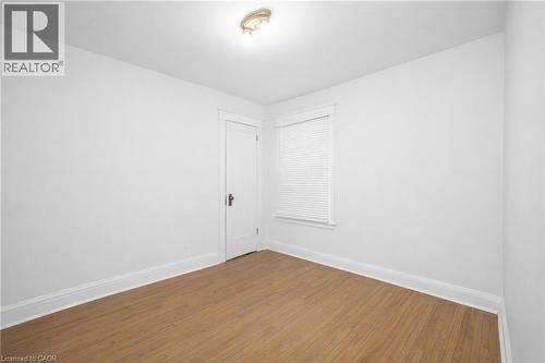 Empty room featuring baseboards and wood finished floors - 43 Sterling Street, Hamilton, ON - Indoor Photo Showing Other Room