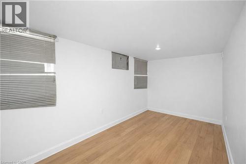 Spare room featuring light wood finished floors and electric panel - 43 Sterling Street, Hamilton, ON - Indoor Photo Showing Other Room