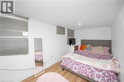Bedroom with light wood finished floors, electric panel, and recessed lighting - 43 Sterling Street, Hamilton, ON - Indoor Photo Showing Bedroom