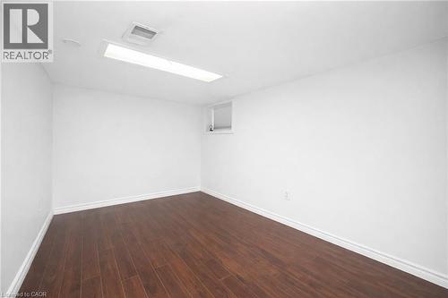 Empty room featuring dark wood finished floors and baseboards - 43 Sterling Street, Hamilton, ON - Indoor Photo Showing Other Room