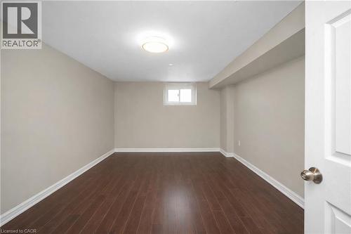 Below grade area featuring baseboards and dark wood-type flooring - 43 Sterling Street, Hamilton, ON - Indoor Photo Showing Other Room