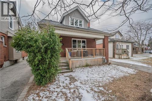 Bungalow with covered porch, brick siding, and roof with shingles - 43 Sterling Street, Hamilton, ON - Outdoor With Deck Patio Veranda