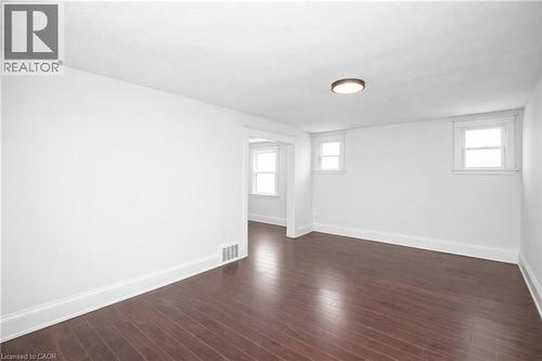 Spare room with healthy amount of natural light and dark wood finished floors - 43 Sterling Street, Hamilton, ON - Indoor Photo Showing Other Room