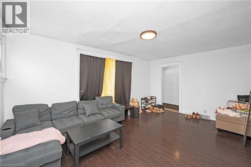 Living room featuring dark wood-style floors - 43 Sterling Street, Hamilton, ON - Indoor Photo Showing Living Room