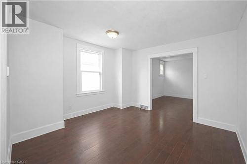 Unfurnished room featuring plenty of natural light and dark wood-style flooring - 43 Sterling Street, Hamilton, ON - Indoor Photo Showing Other Room
