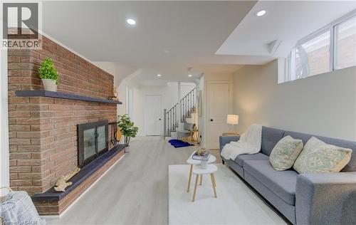 Living area with recessed lighting, light wood finished floors, and a fireplace - 171 Sixth Avenue, Kitchener, ON - Indoor Photo Showing Living Room With Fireplace