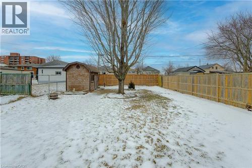 Snowy yard with a fenced backyard and an outbuilding - 171 Sixth Avenue, Kitchener, ON - Outdoor