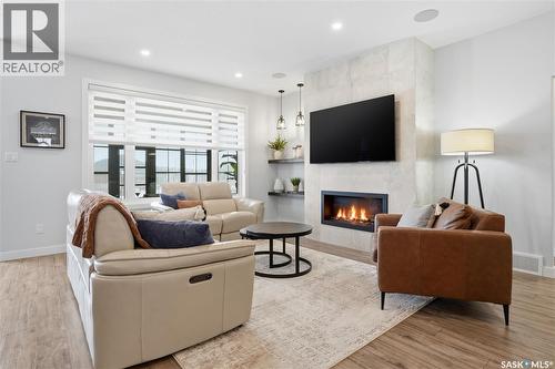 4418 Sage Crescent E, Regina, SK - Indoor Photo Showing Living Room With Fireplace