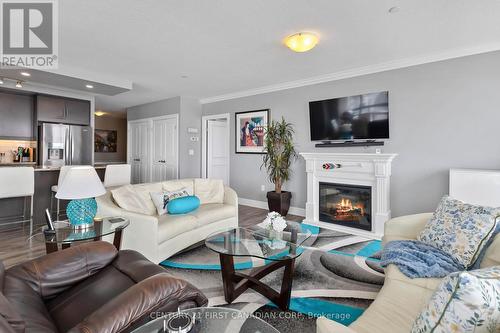Living/dining - NW facing - 411 - 260 Villagewalk Boulevard, London North (North R), ON - Indoor Photo Showing Living Room With Fireplace