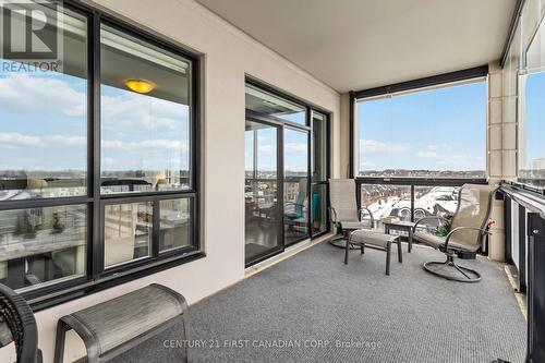 Enclosed balcony - NW facing - glass panels - 411 - 260 Villagewalk Boulevard, London North (North R), ON -  With Balcony With Exterior