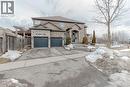 French provincial home with brick siding, asphalt driveway, and an attached garage - 2 Doon Creek Street, Kitchener, ON  - Outdoor With Facade 
