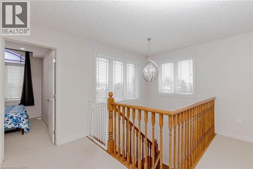 Hallway with an upstairs landing, light carpet, and healthy amount of natural light - 2 Doon Creek Street, Kitchener, ON - Indoor Photo Showing Other Room